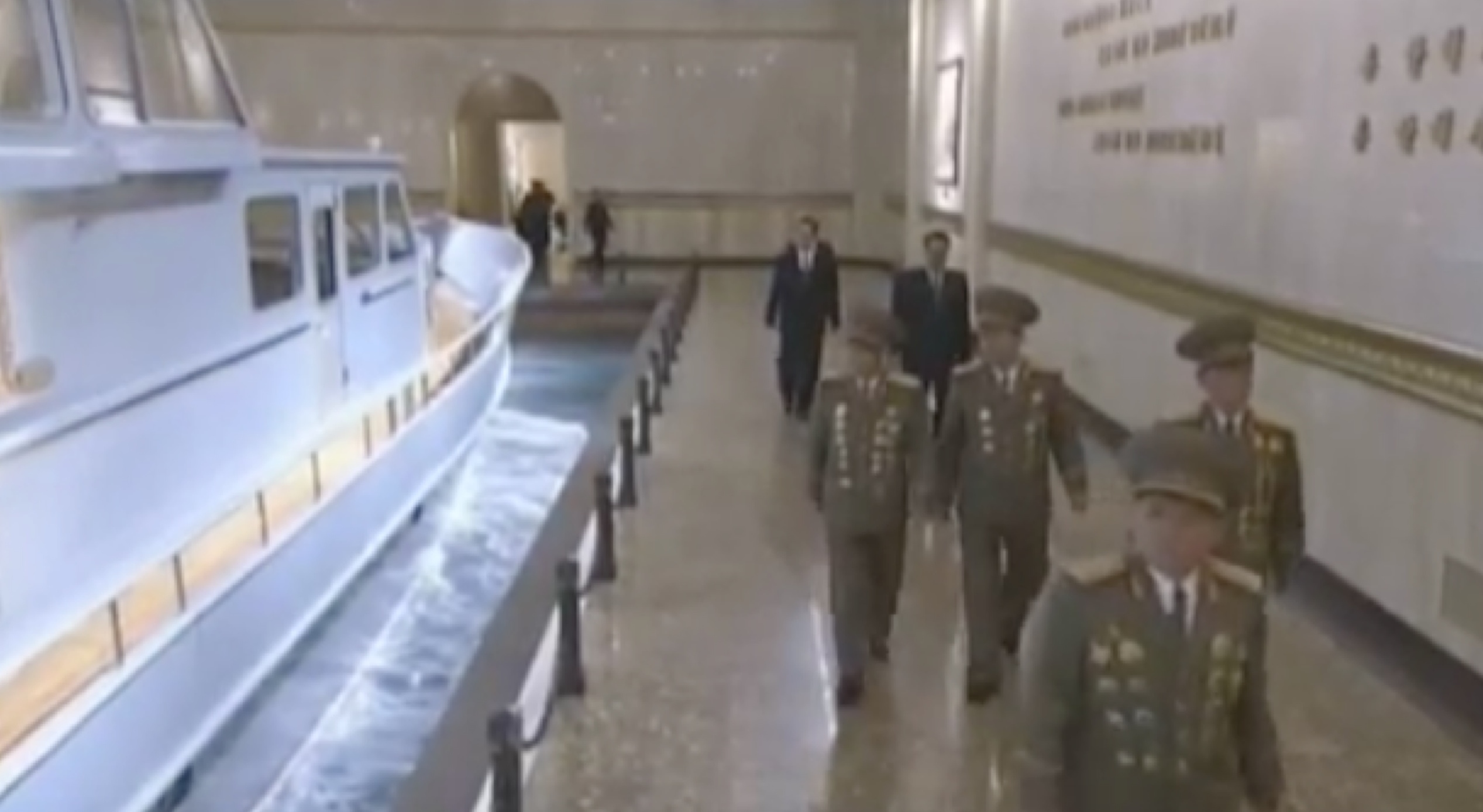 Senior KPA command staff and WPK cadres file past a display of Kim Jong Il's personal boat on February 16, 2017 at the Ku'msusan Palace of the Sun in Pyongyang (Photo: Korean Central Television).