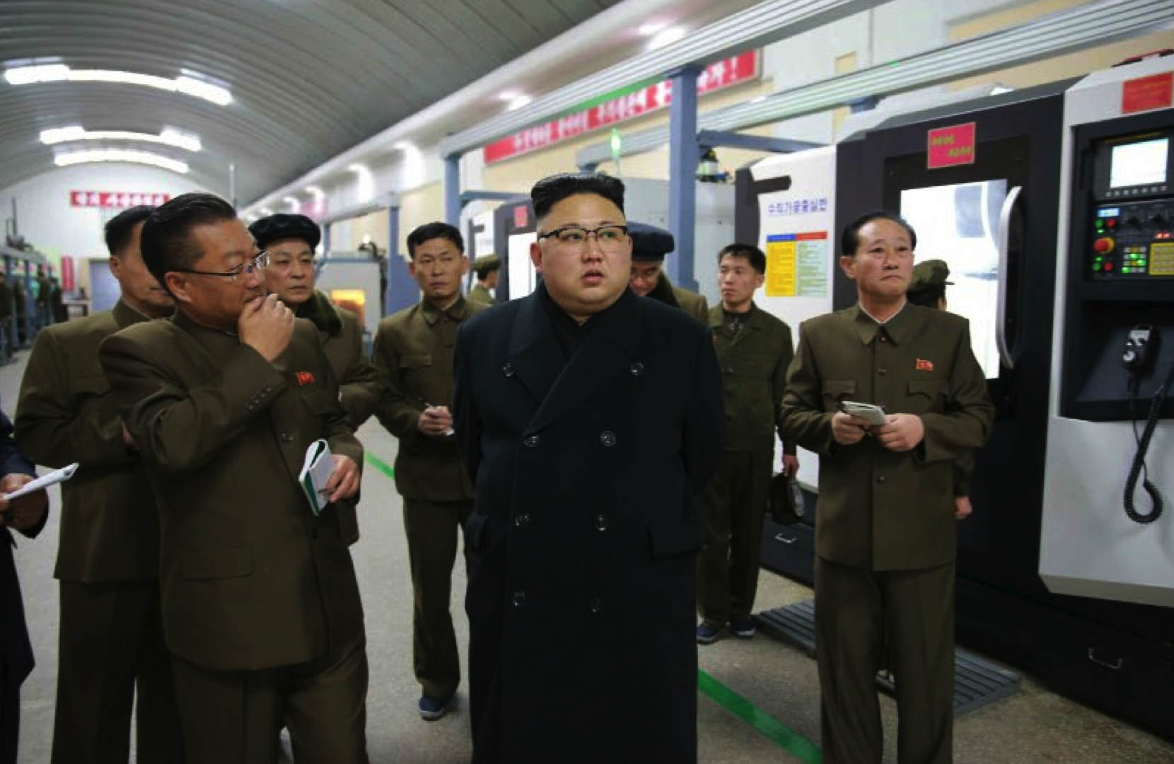 Kim Jong Un is briefed about production at the Kangdong Precision Machine Plant in the suburbs of Pyongyang in a photo which appeared top-center on the front page of the February 7, 2017 edition of WPK daily organ Rodong Sinmun (Photo: Rodong Sinmun).